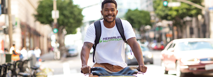 Man On Bike With Herbalife Nutrition Tshirt