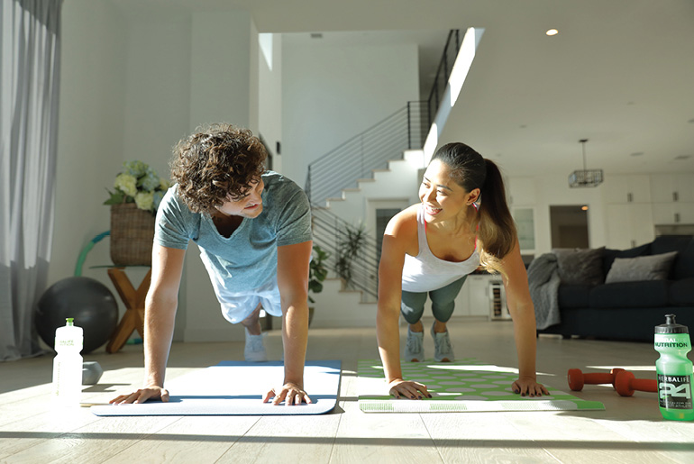 Couple Exercising At Home
