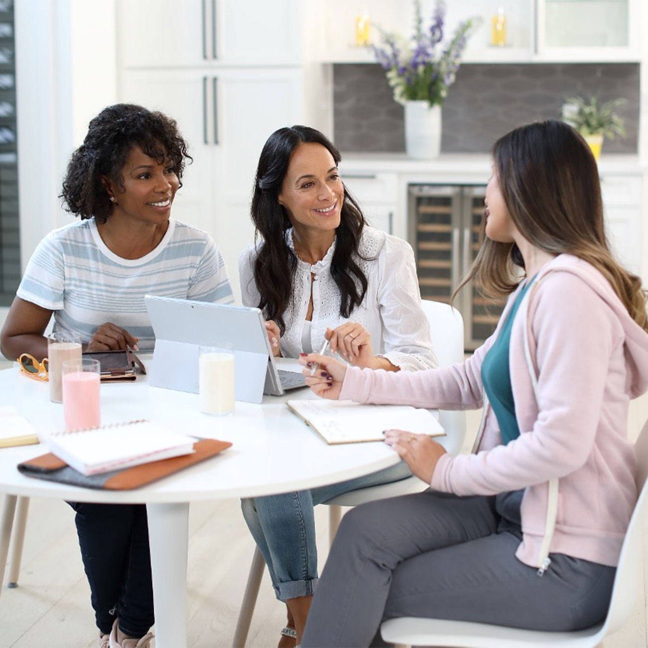 Herbalife Nutrition members at a table, smiling and having a conversation