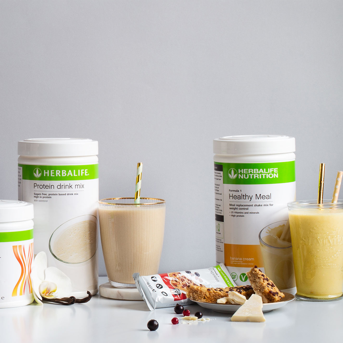 Herbalife Nutrition products, shakes and protein bars displayed on a white table