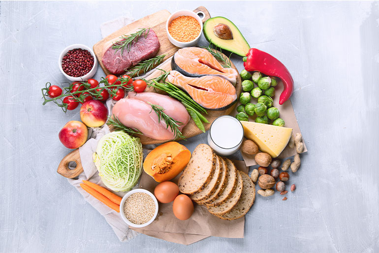 Overhead shot of micronutrient-rich foods placed on a light grey surface