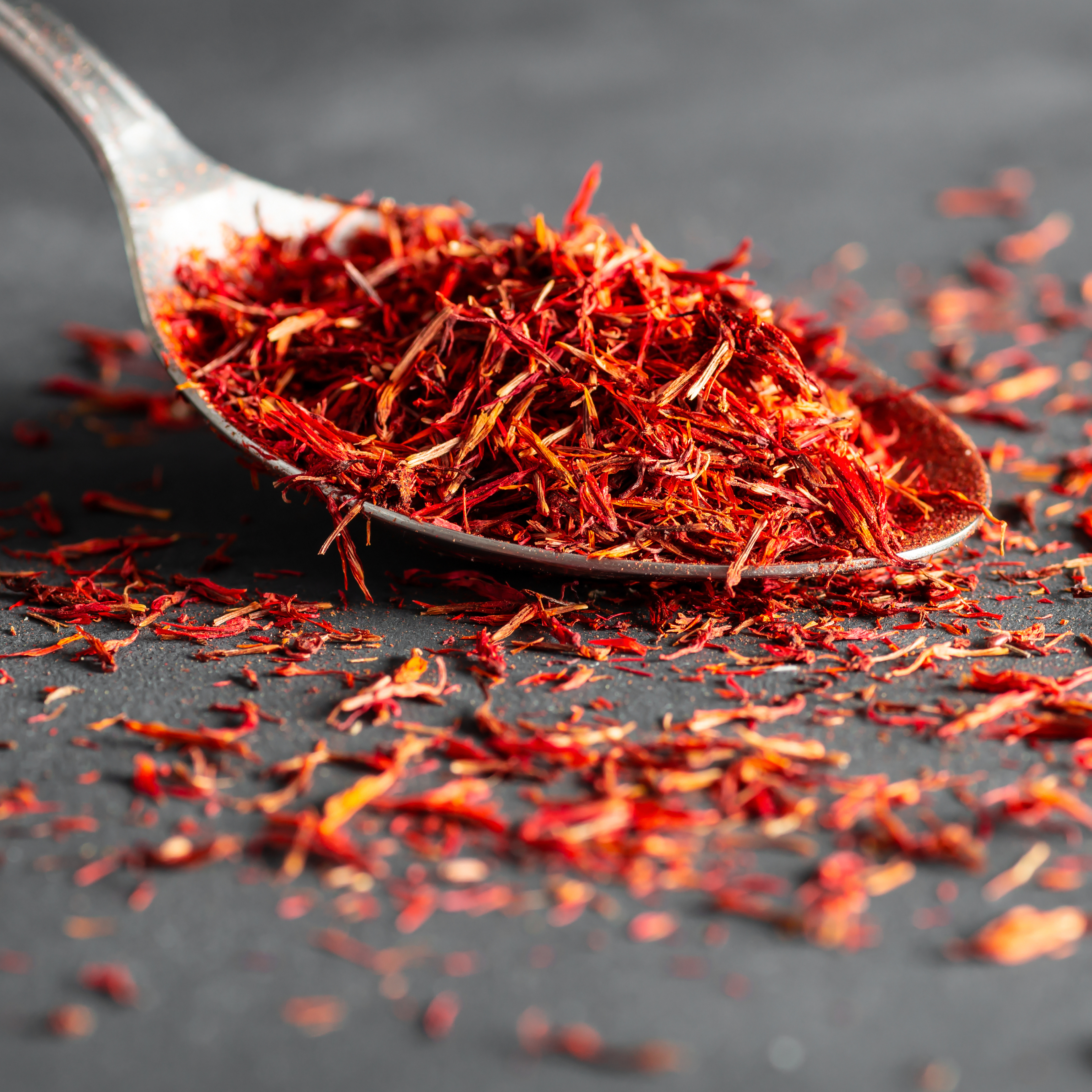 A spoon of saffron spice on a table