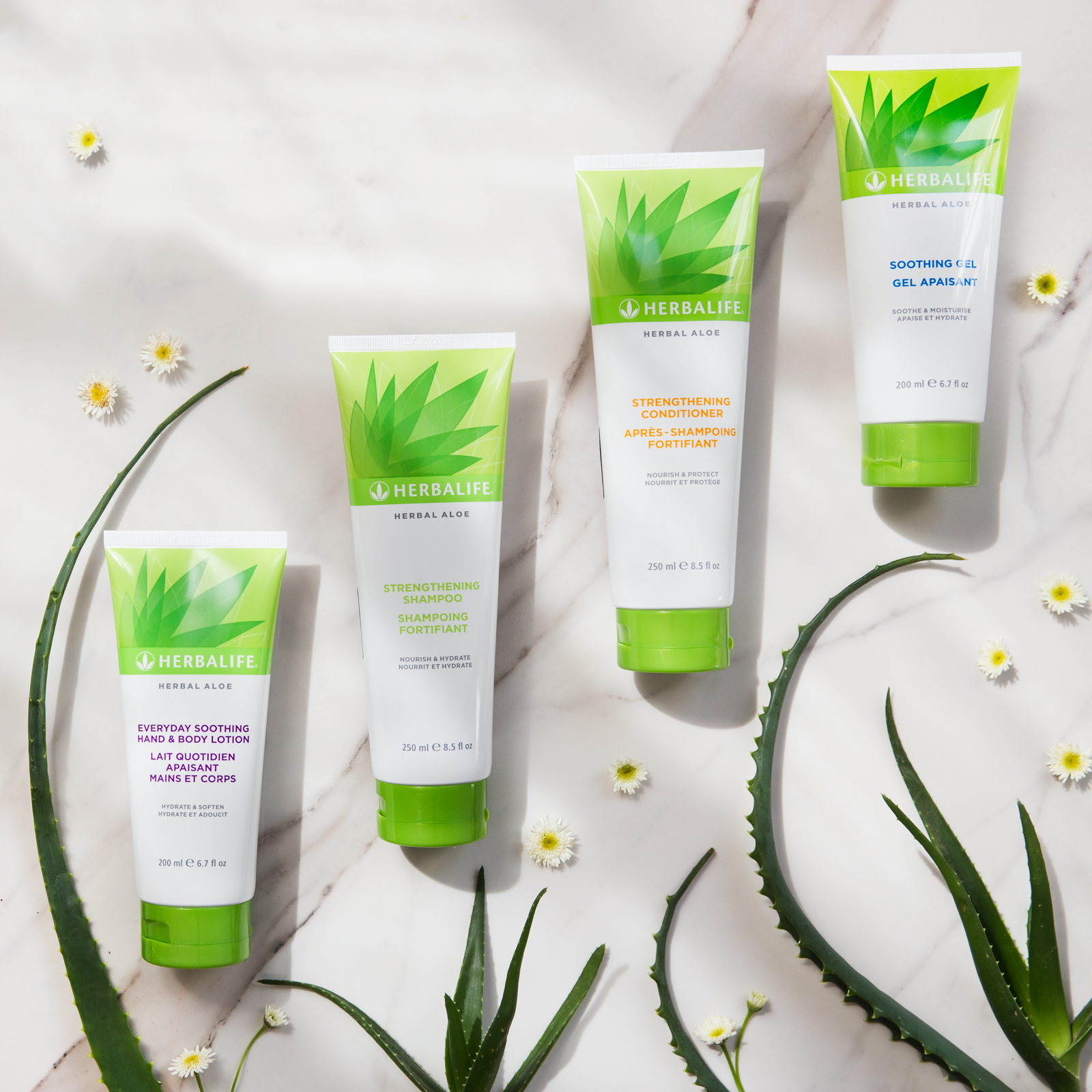 Herbal Aloe skincare and haircare products on a marble table