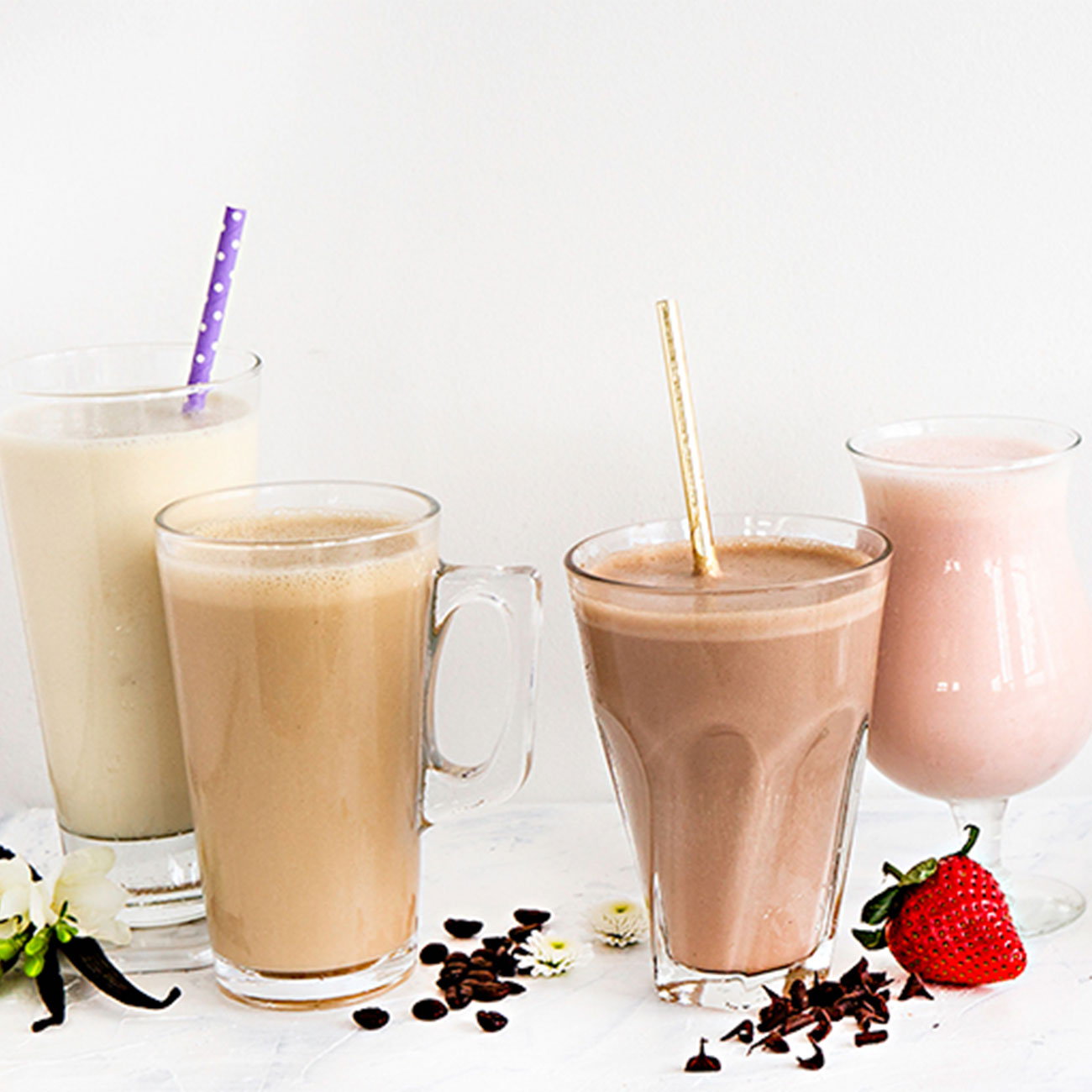 Different flavours of Herbalife Nutrition Formula 1 protein shakes in glasses with straws