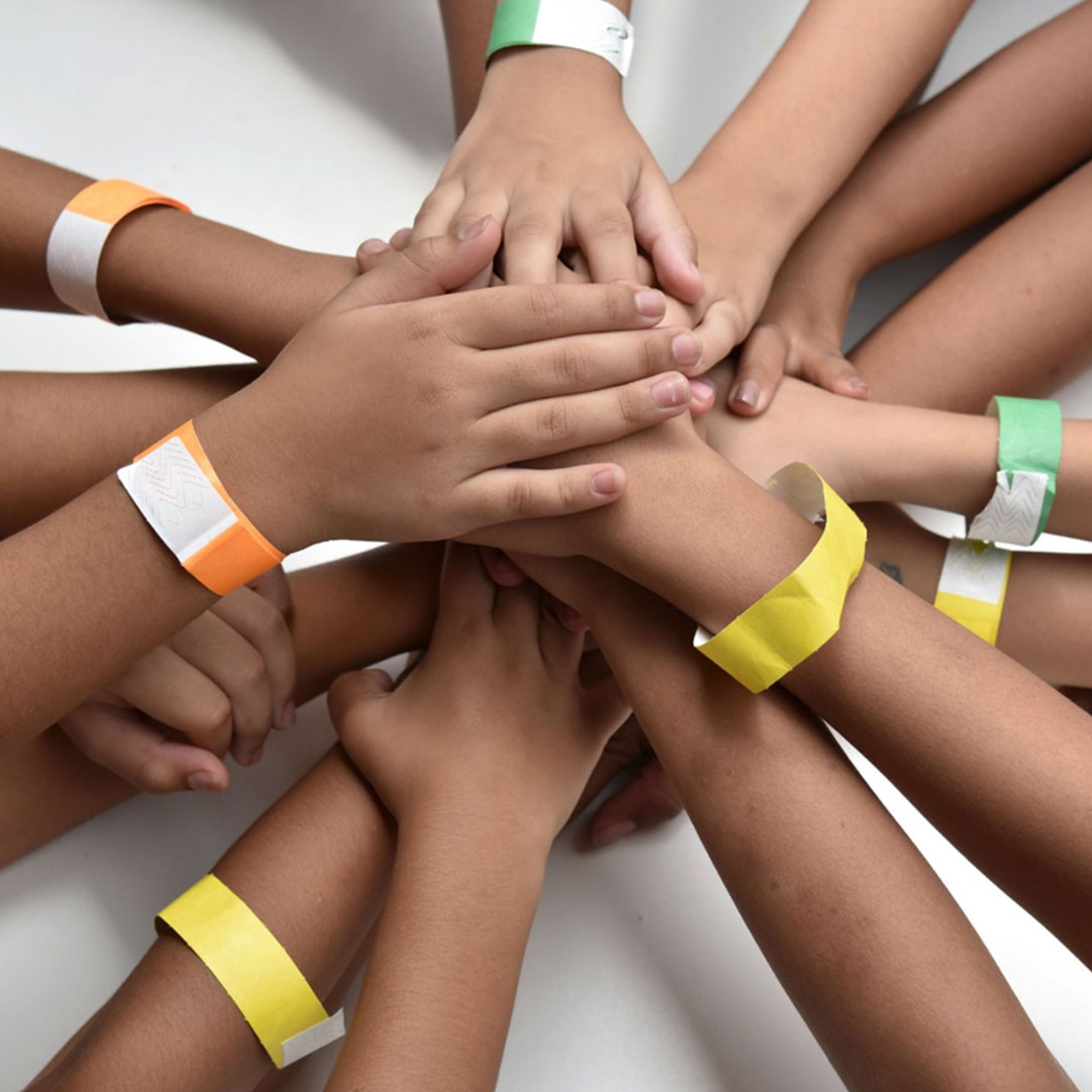 herbalife nutrition foundation group of children with hands stacked on top of each other