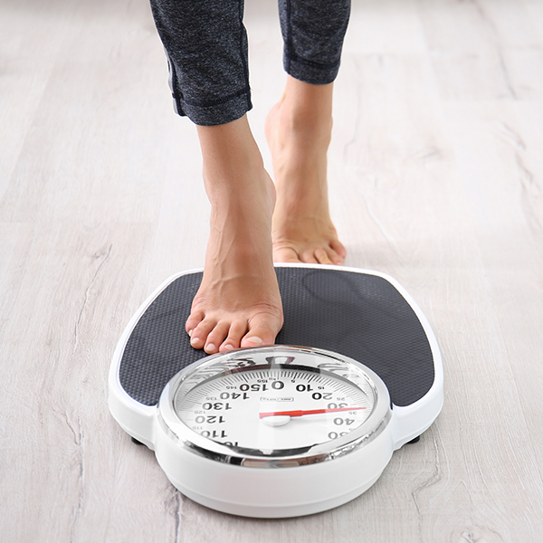 Image of a person stepping on a scale