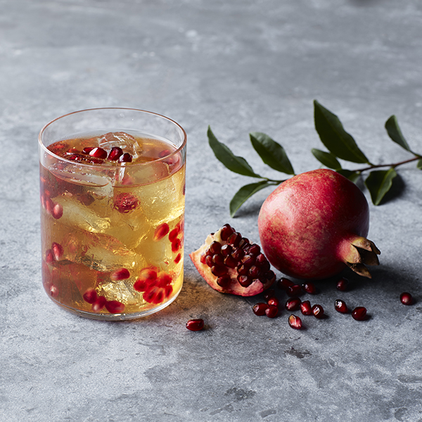 Image of a glass of a fresh beverage with pomegranate